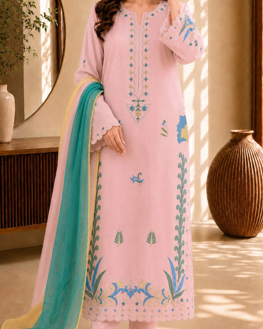 Pink embroidered dress with a green dupatta in a decorative setting