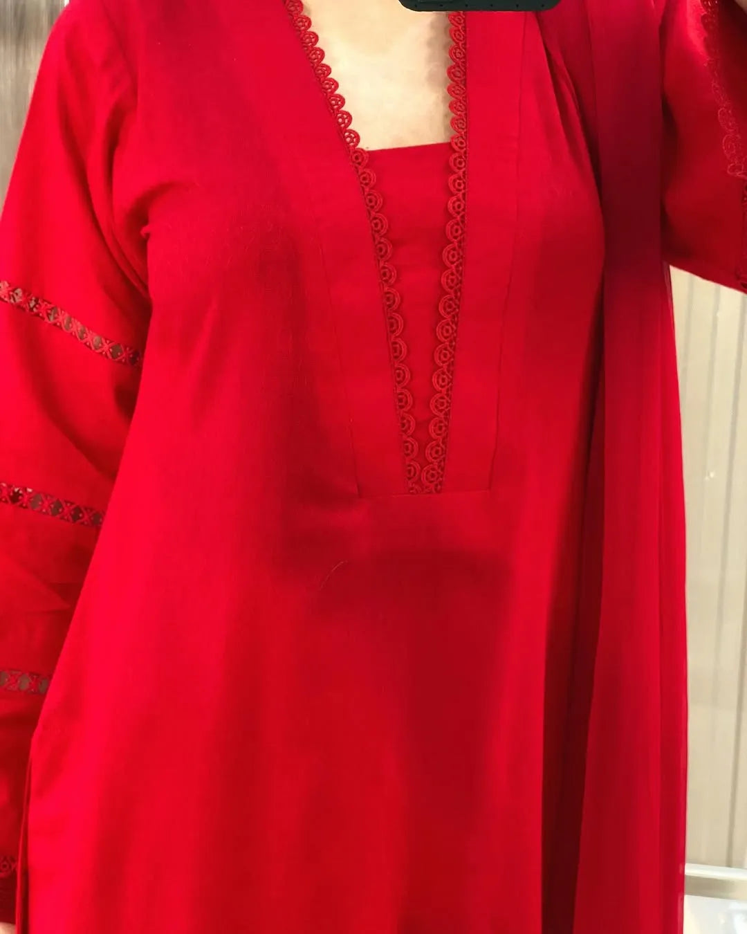 Red outfit with intricate detailing on a plain background