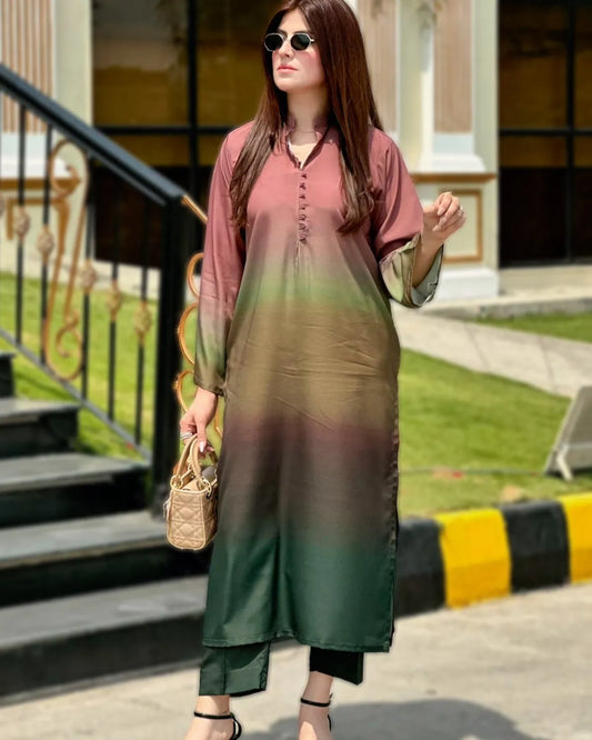 Woman wearing a gradient dress standing outdoors with greenery and steps in the background
