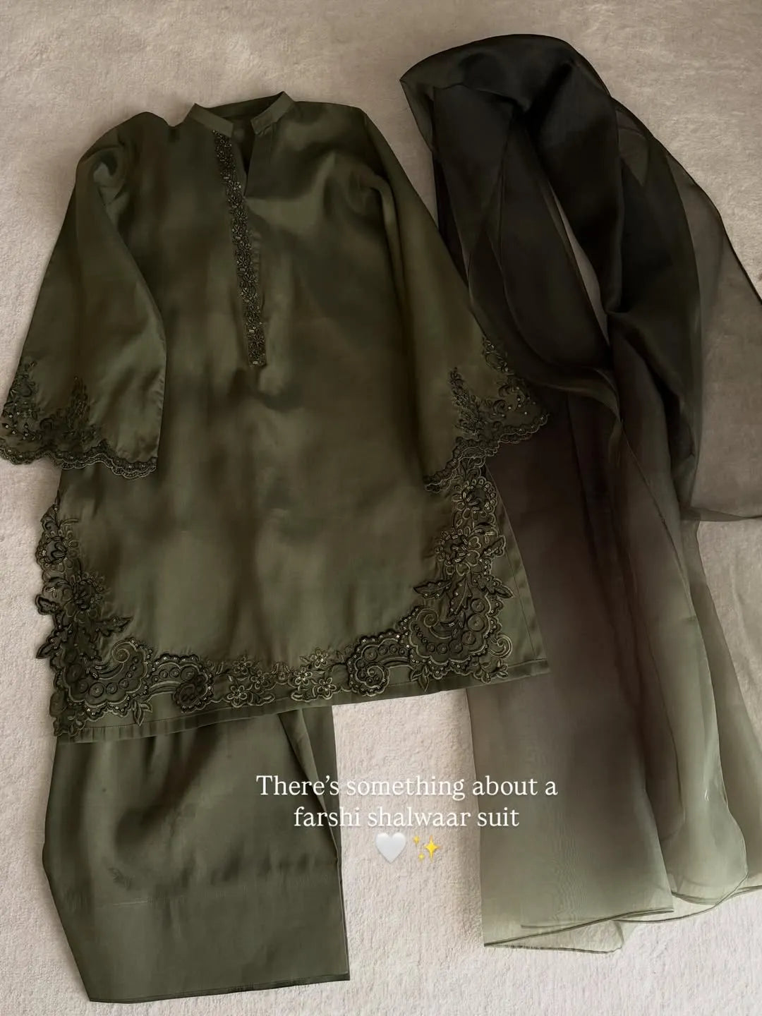 Green outfit with lace details on a neutral background