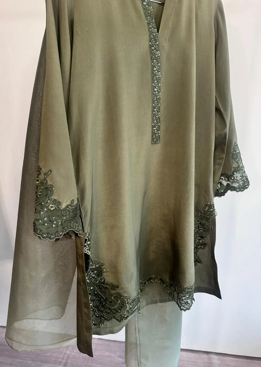 Olive green dress with floral embroidery on a white background