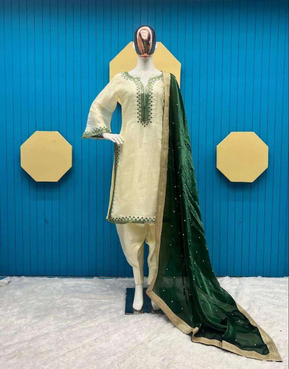 Mannequin wearing a traditional outfit with a green dupatta against a blue background