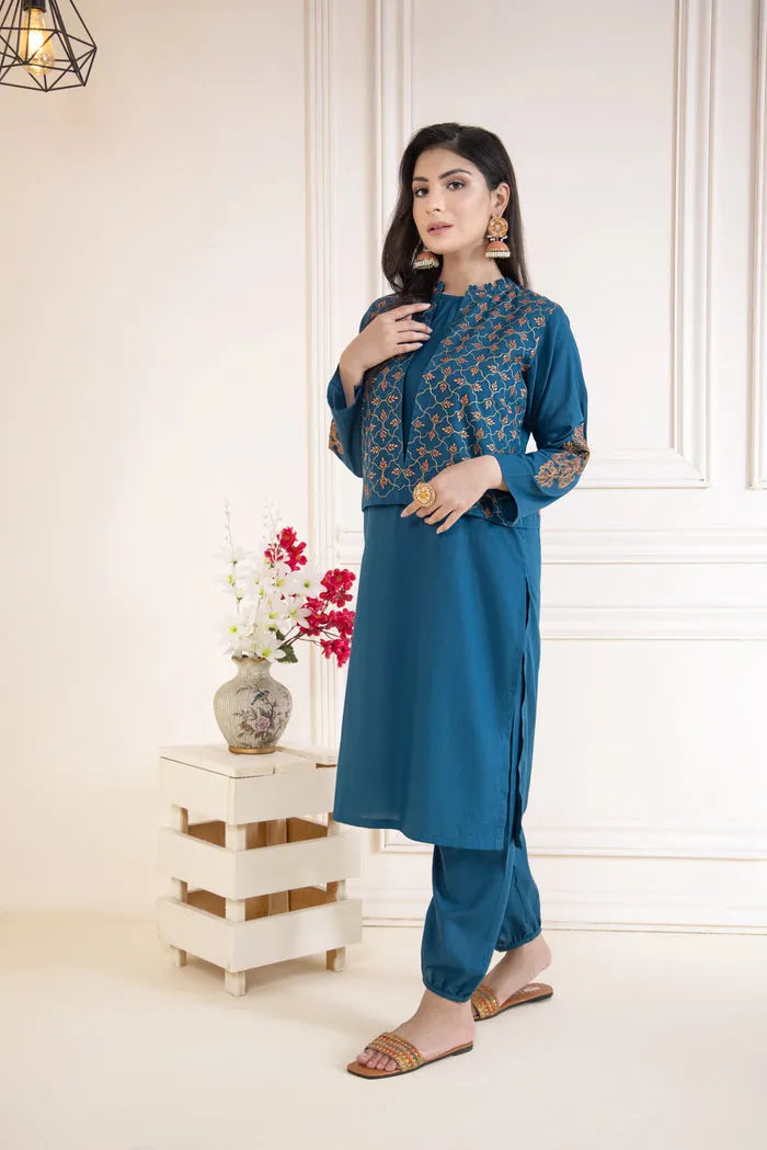 Woman wearing a blue traditional outfit with a white background