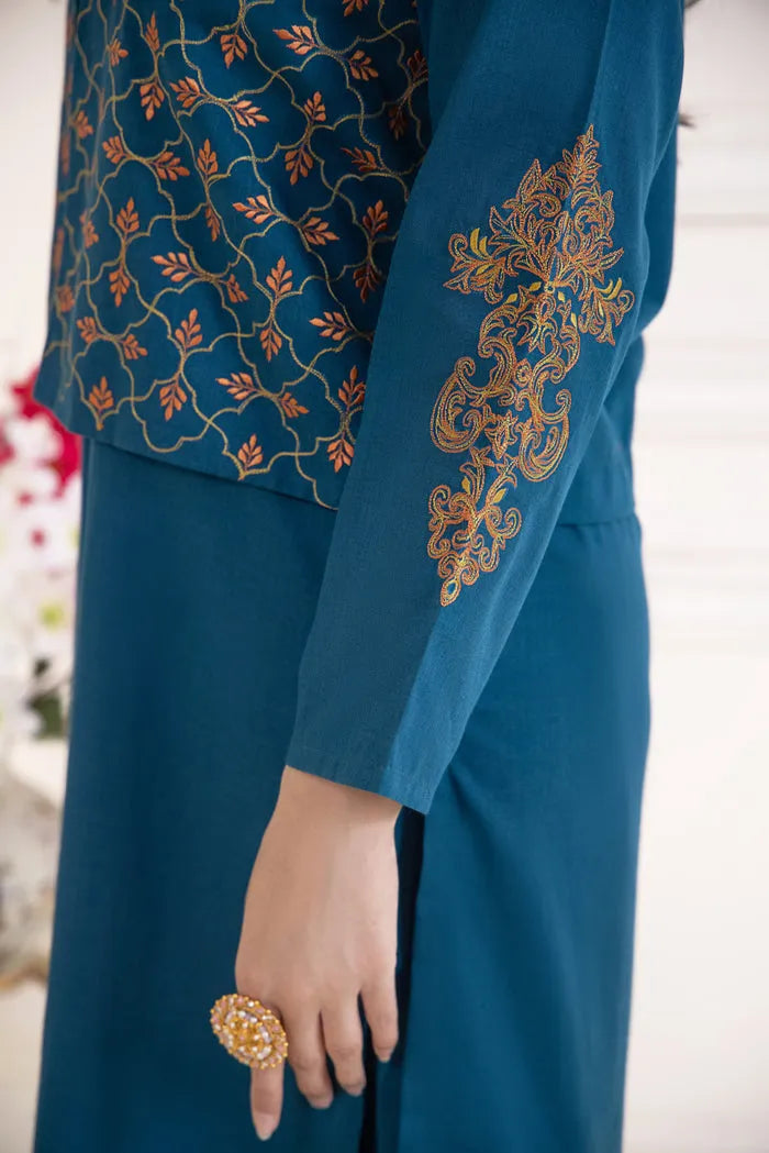 Teal outfit with gold embroidery on a blurred background