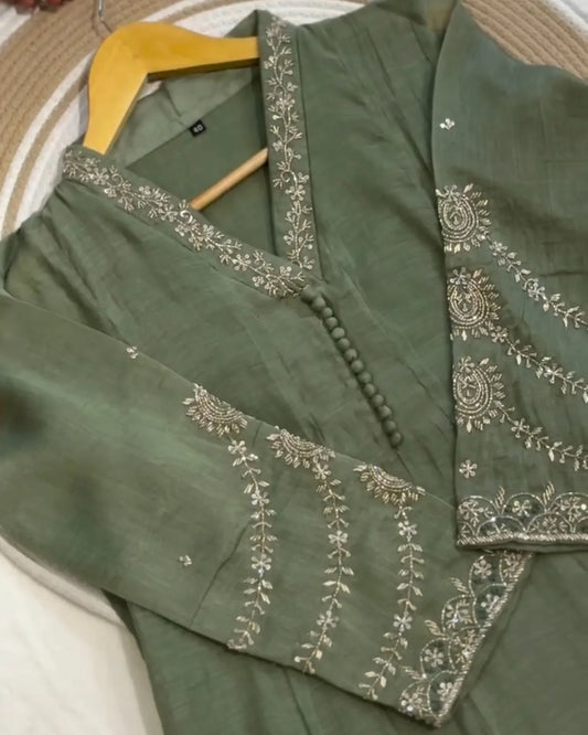 Green embroidered garment on a hanger