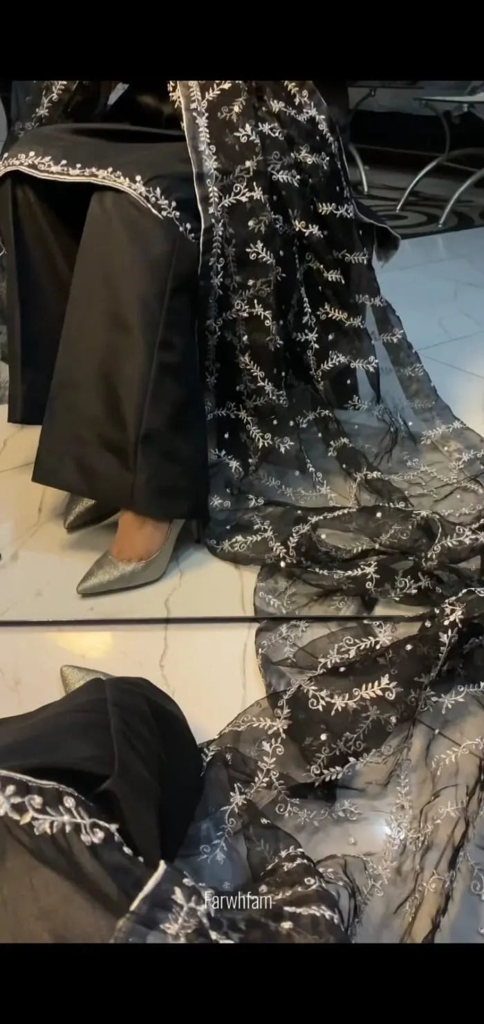 Person wearing a black and silver dress with a reflective surface