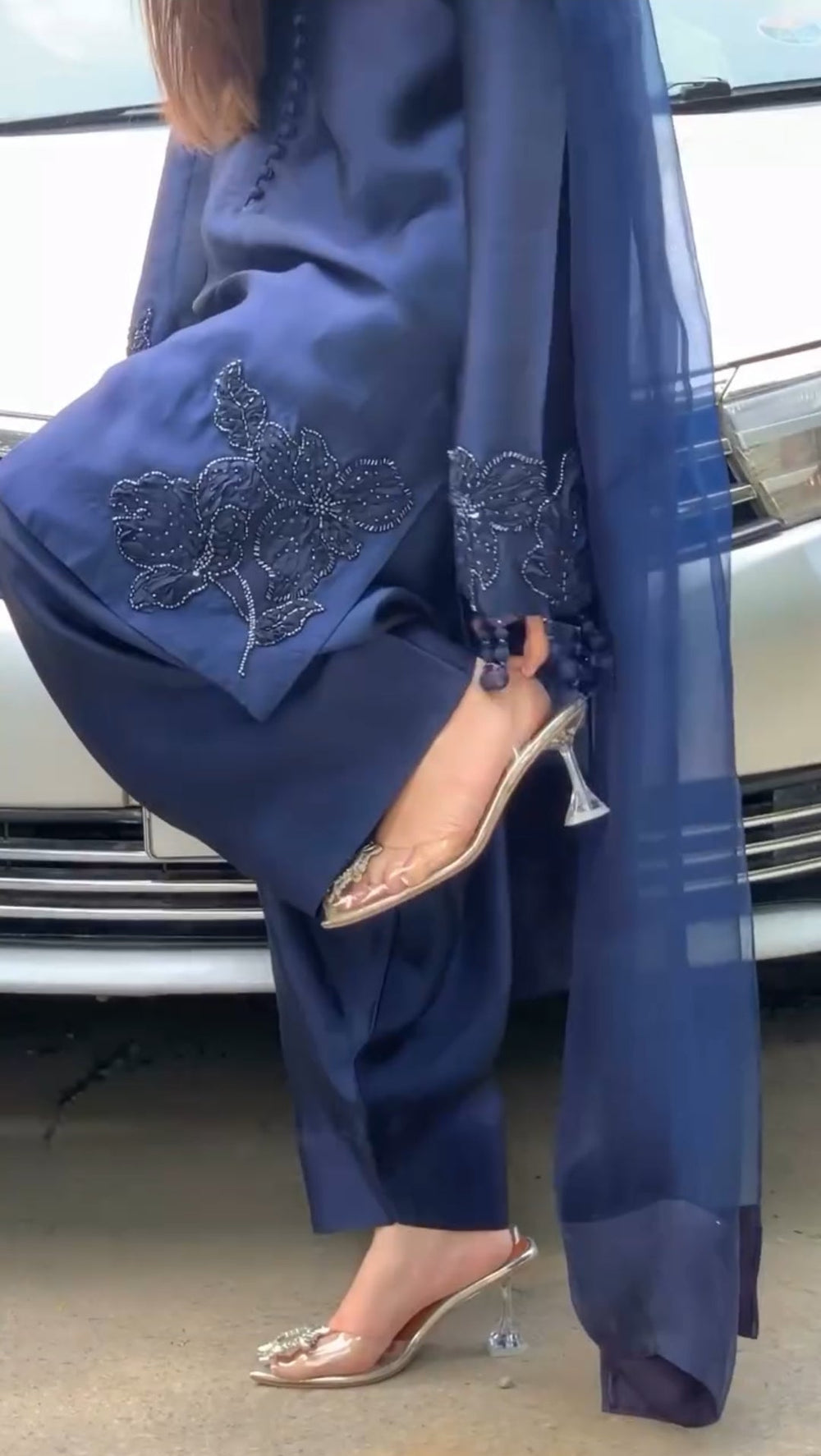 Navy blue traditional outfit with intricate designs and matching shoes.