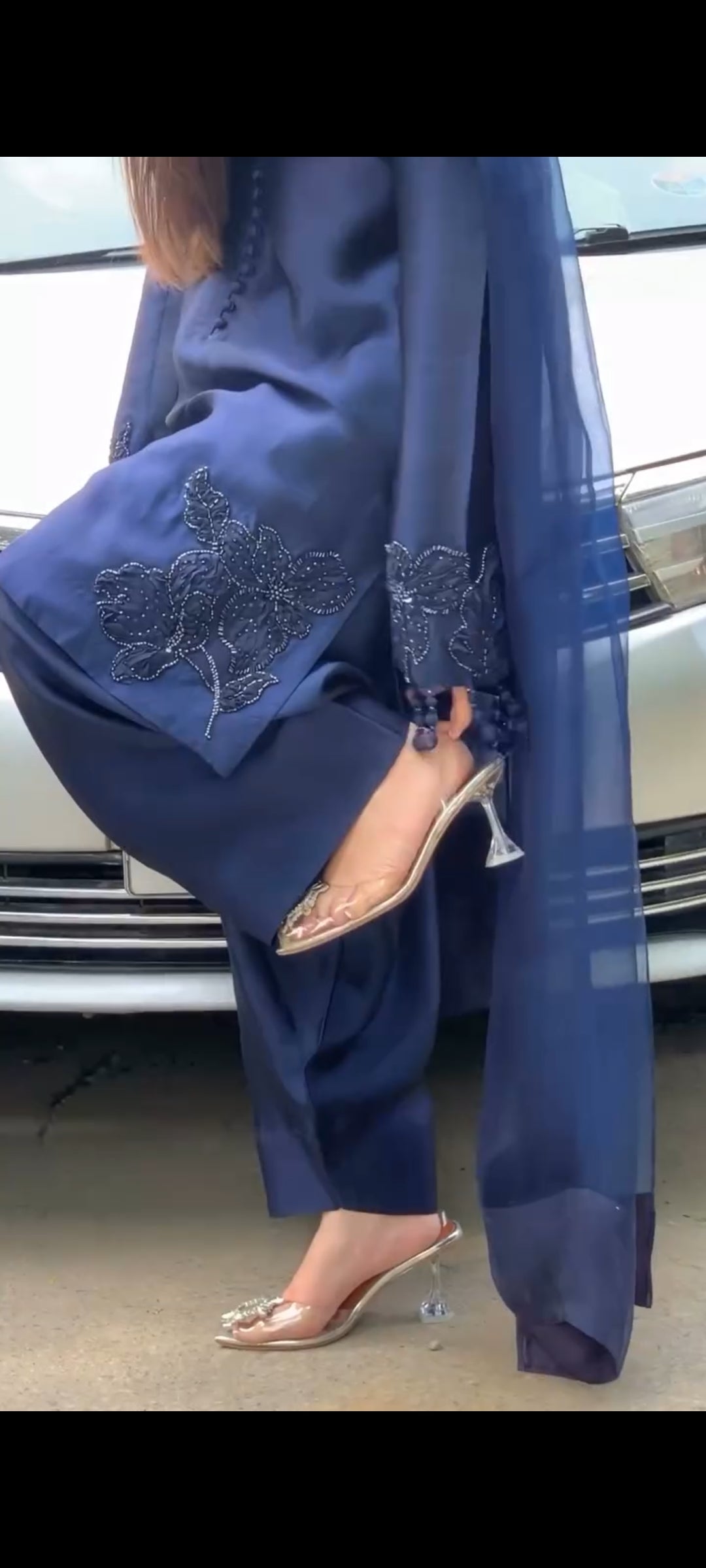 Navy blue traditional outfit with embroidered details and matching shoes.