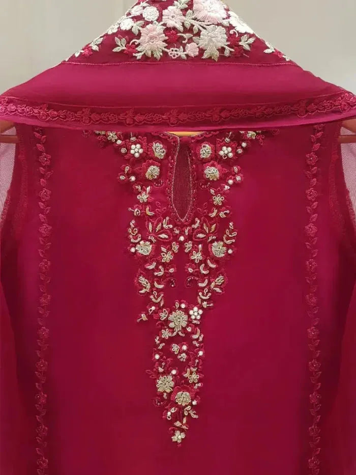 Red garment with floral embroidery on a plain background