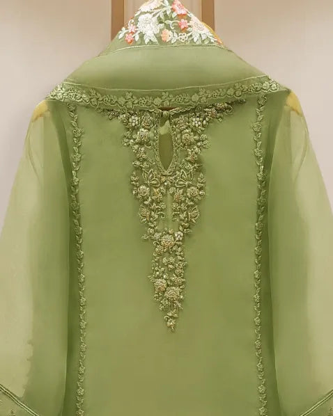 Green embroidered garment on a mannequin against a plain background